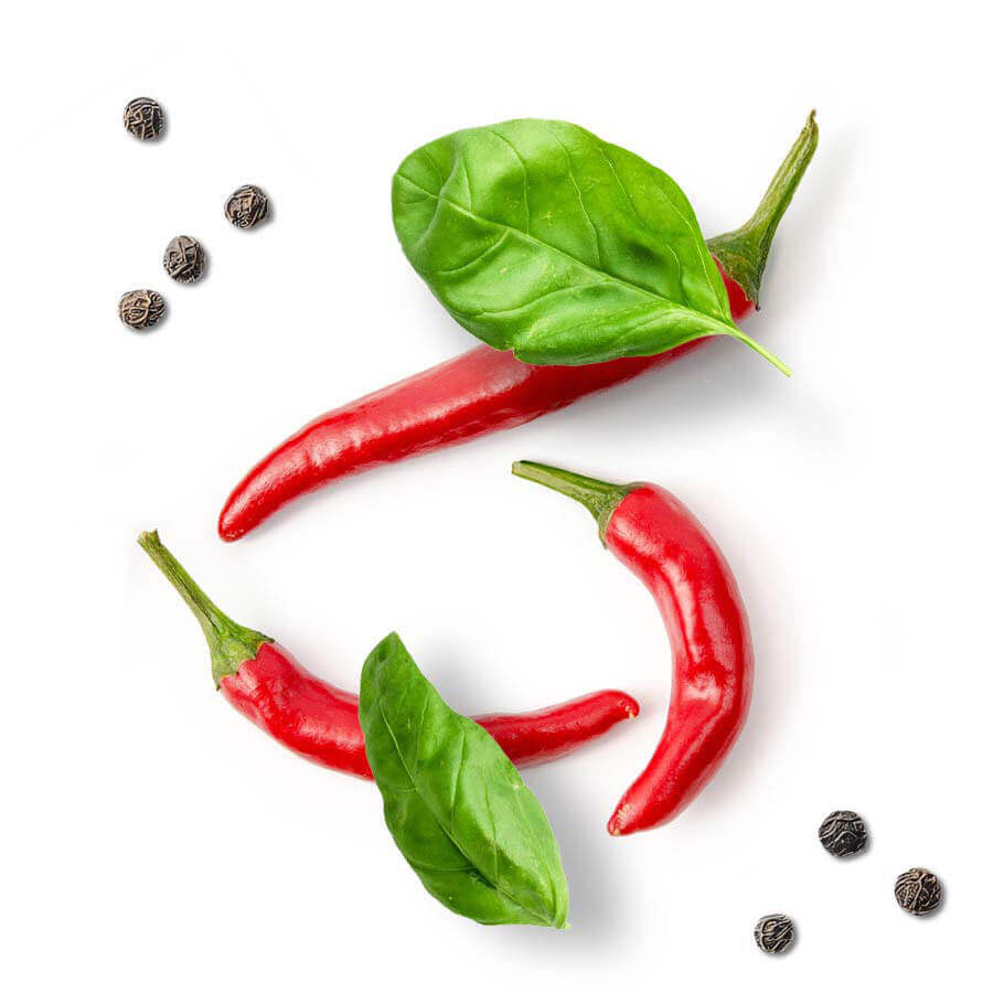 Three red chilli peppers, basil and pepper